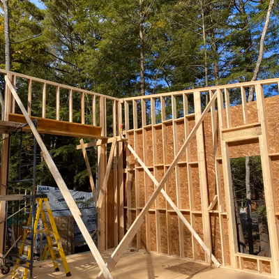 Close-up exterior view of a wooden house frame under construction